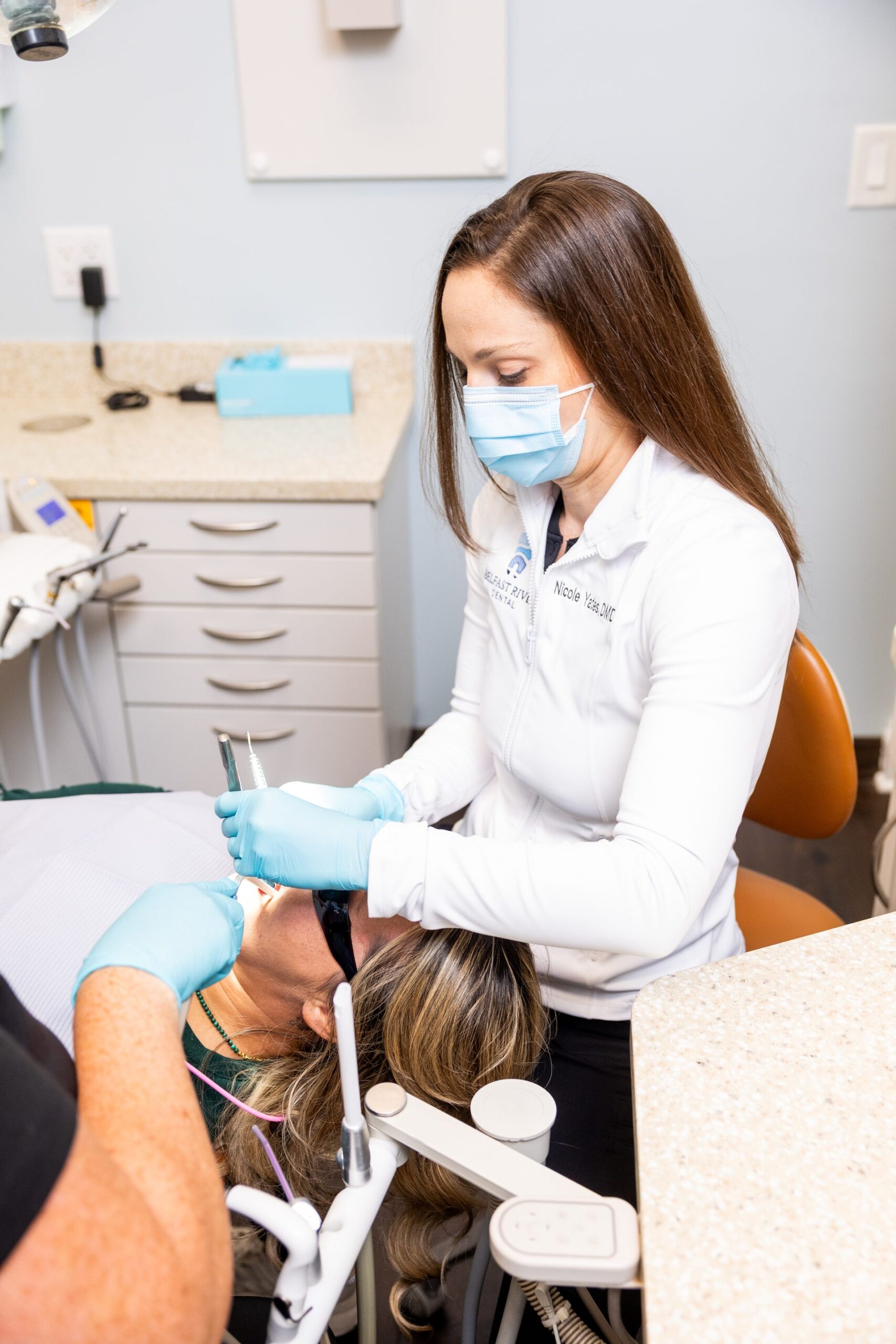 Dr. Nicole Yates performing a chairside procedure at Belfast River Dental
