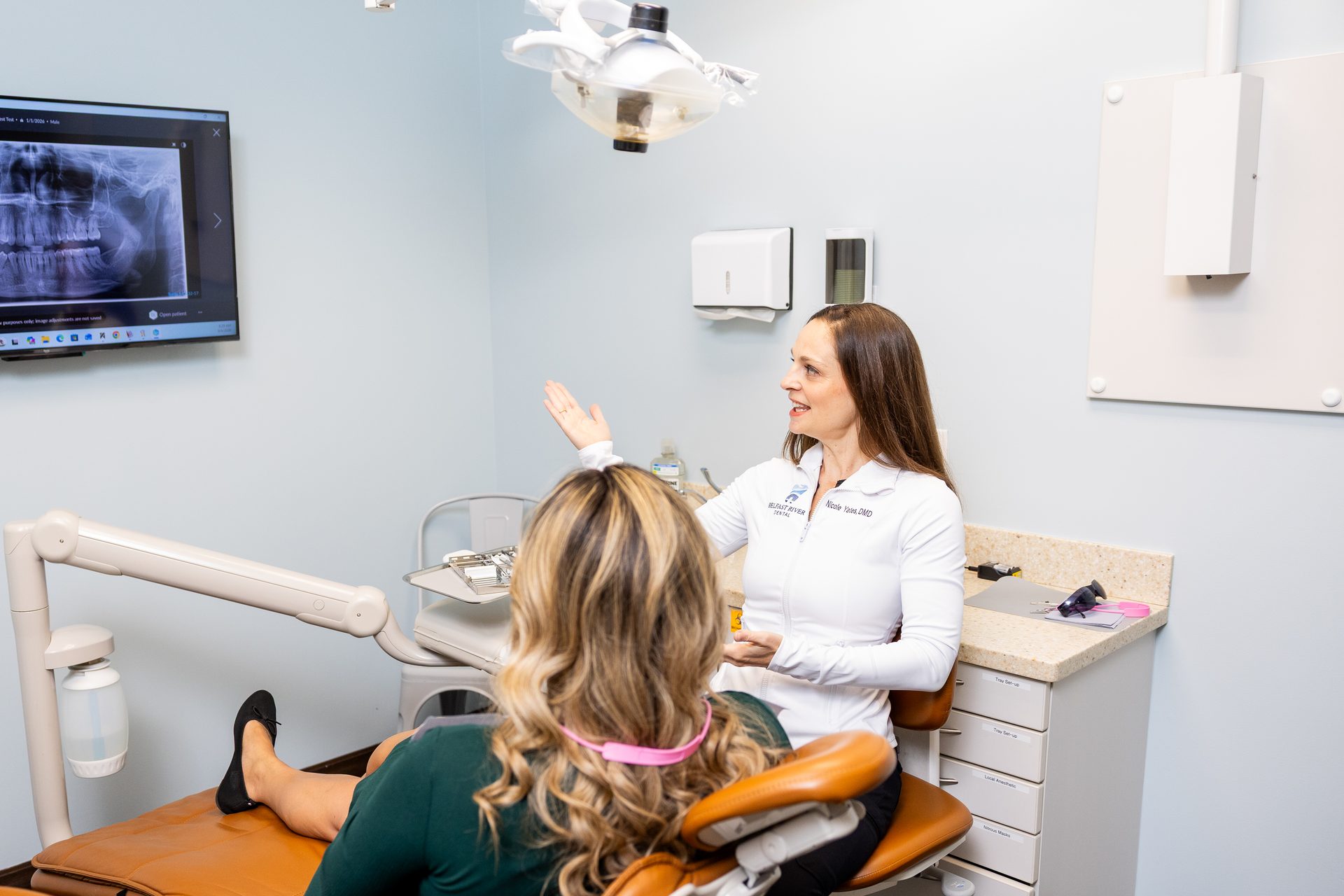 Dr. Nicole Yates reviewing an X-ray with a patient at Belfast River Dental