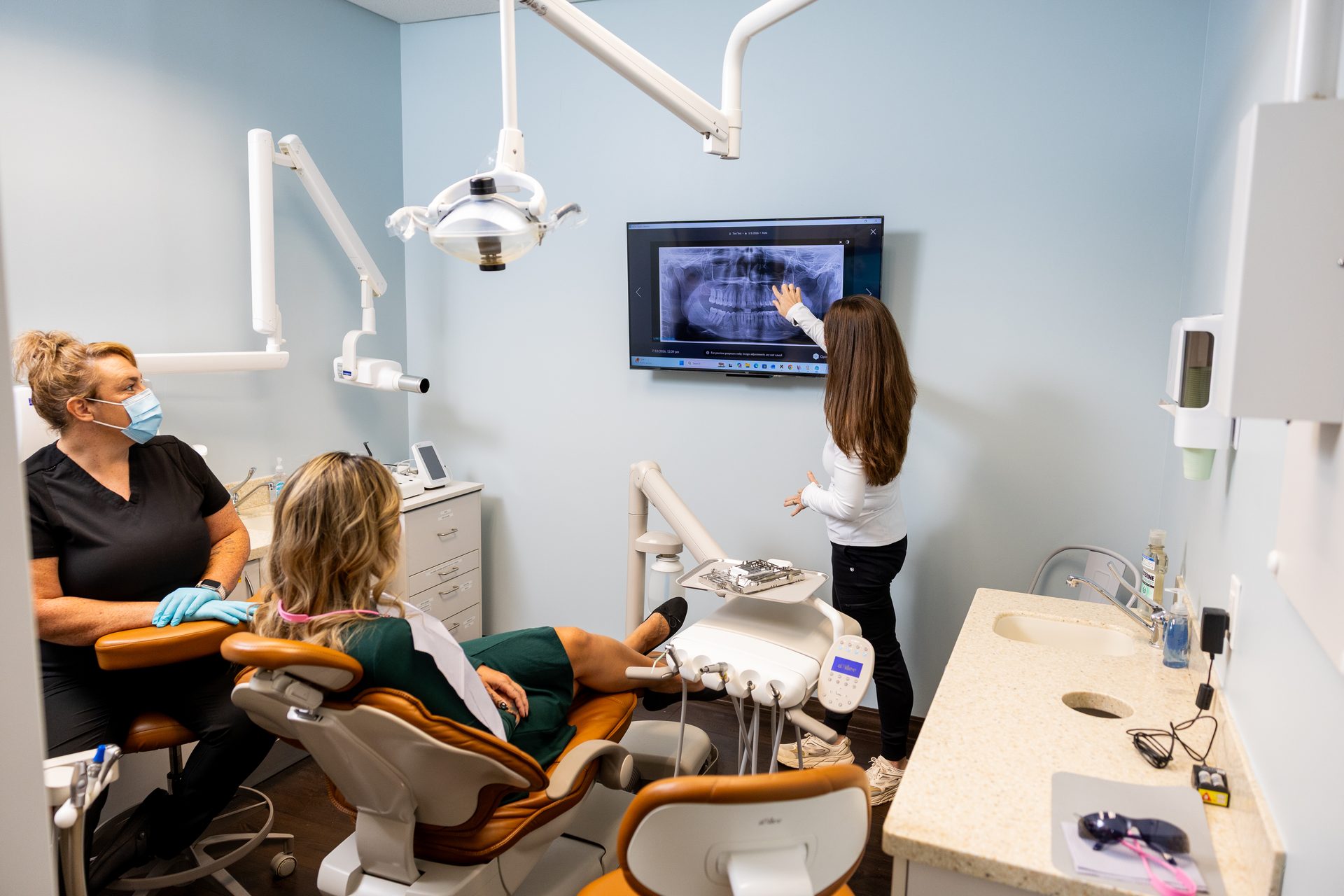 Dr. Nicole Yates planning treatment from an X-ray at Belfast River Dental